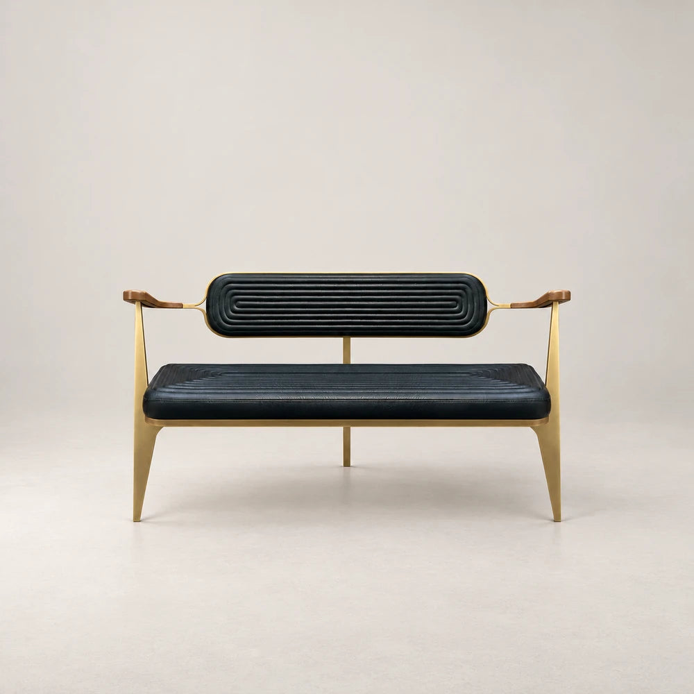 Front view of the BH01 Bench by Eva Szumilas, featuring ribbed black leather seat and back cushions, wooden armrests and slender gold-toned legs.